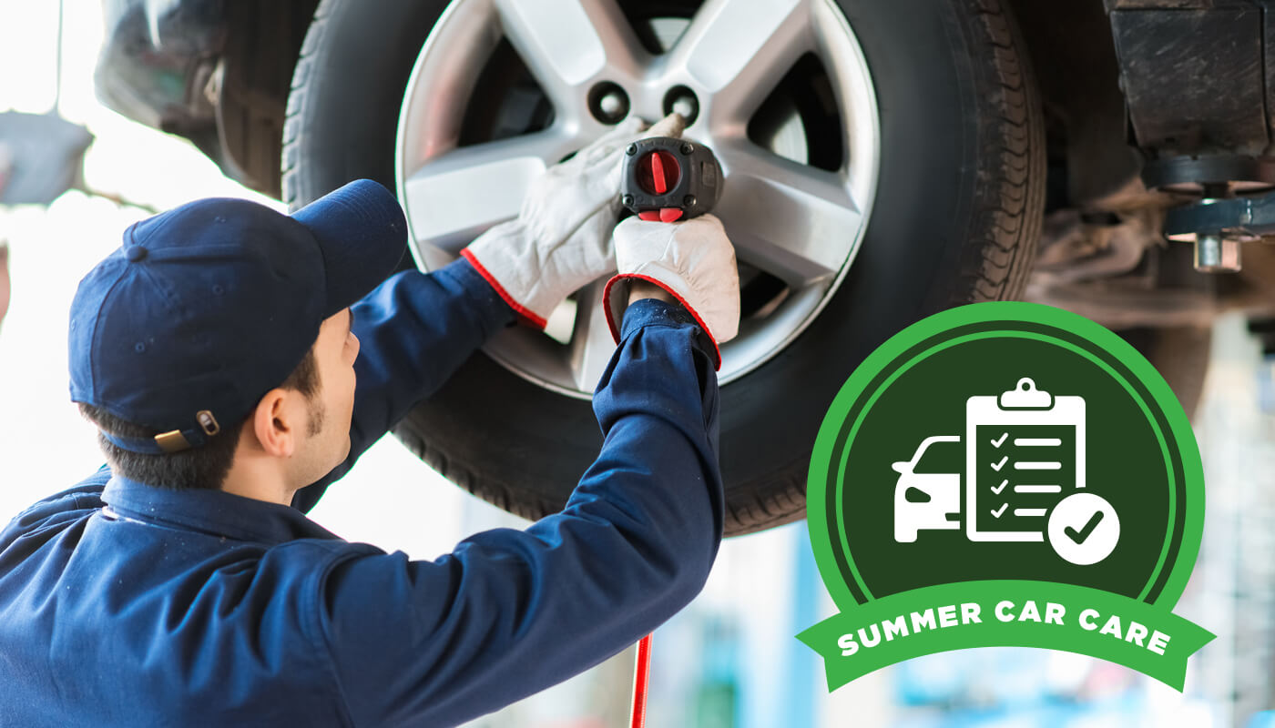 Summer Car Care: 4 Ways to Protect Your Vehicle During the Hottest Months of the Year - An image of a person repairing the wheels on a car.