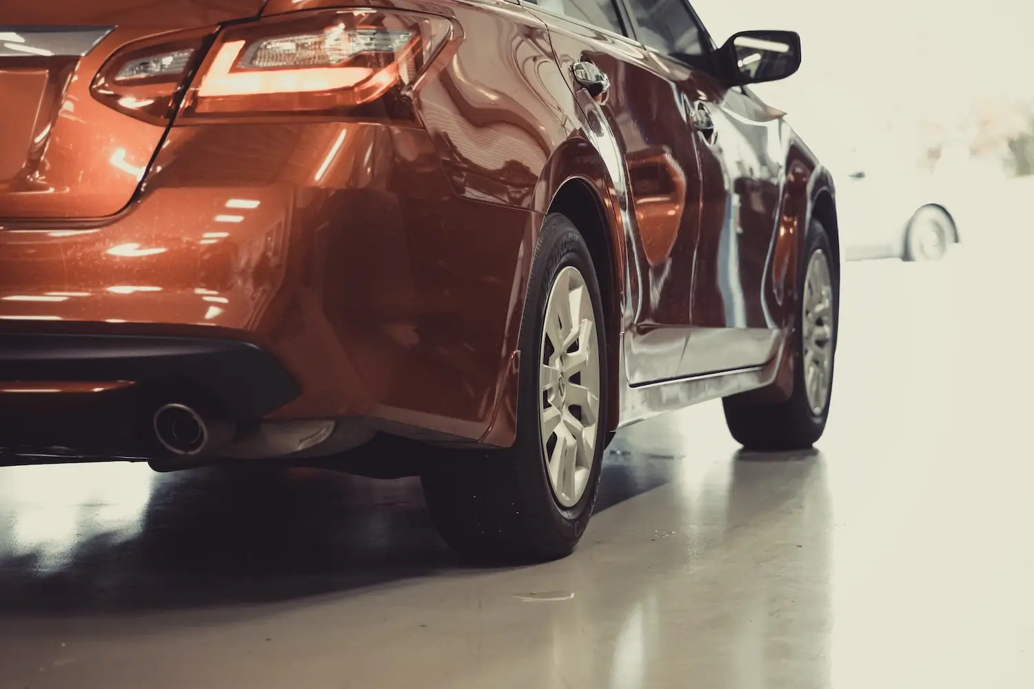 will insurance pay for rental car during repairs - An image of a damaged vehicle awaiting repairs in a repair shop.