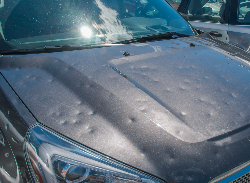 Does Car Insurance Cover Hail Storm Damage - An image of a car damaged by hail.