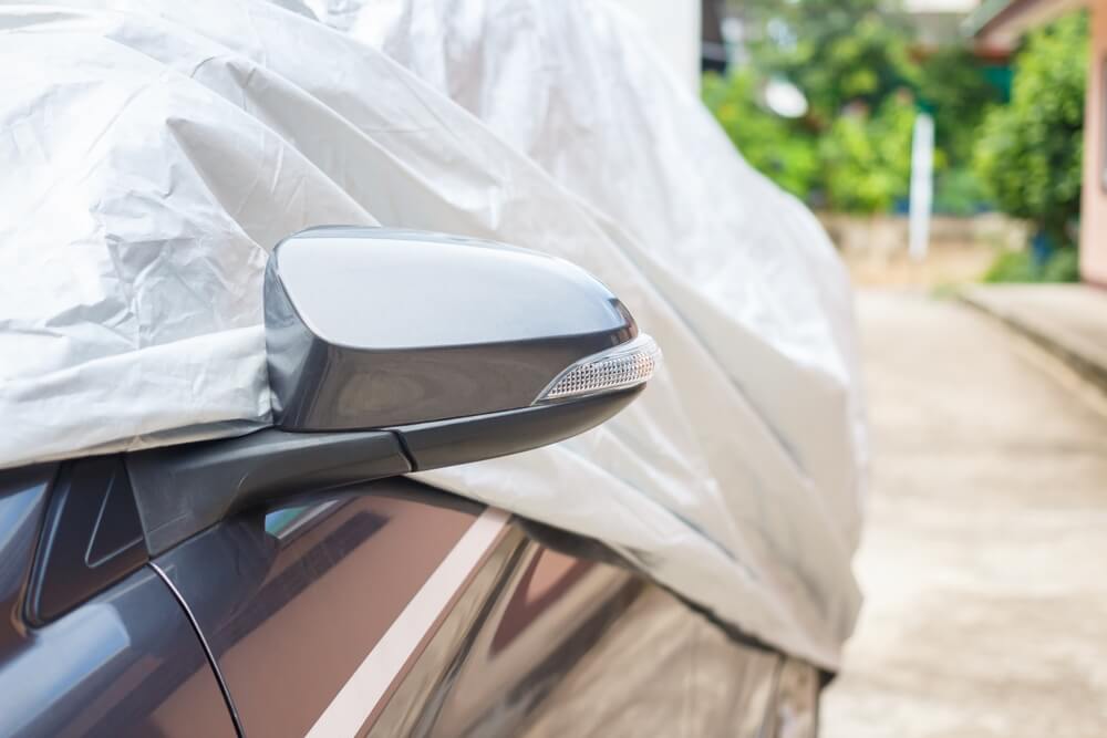 Does my car need insurance if i'm not driving it? - An image of a vehicle under a protective cover.