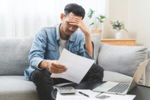 Cheap Car Insurance for Bad Credit - An image of a man upset over a recent car insurance bill