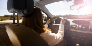 woman driving car on a sunny day