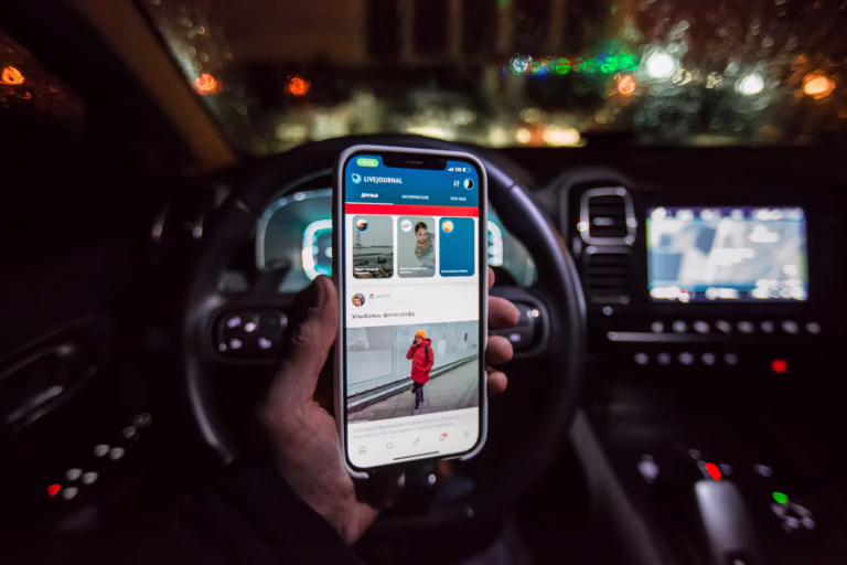 A smartphone app showing a driving score next to a car, representing usage-based insurance.